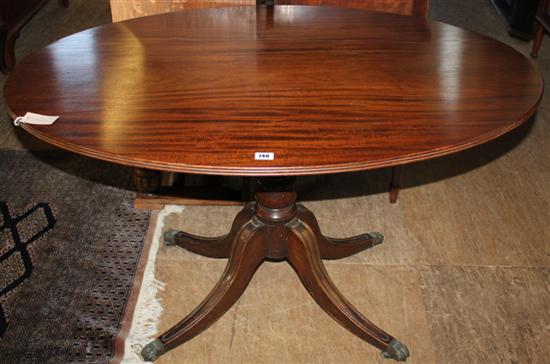 Regency style mahogany oval tilt-top dining table